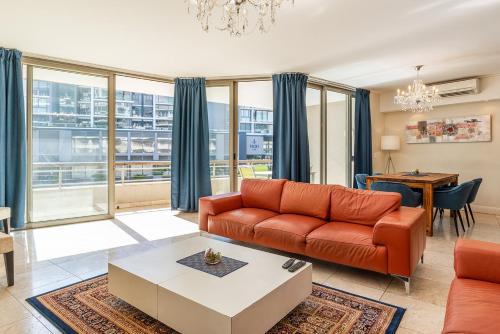 a living room with a couch and a table at V&A Waterfront Luxury by NIVAR in Cape Town
