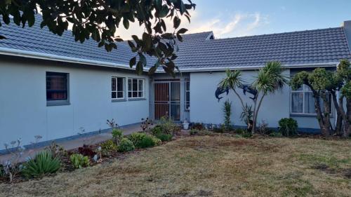 a white house with a yard in front of it at Silva Dolphin in Vredenburg