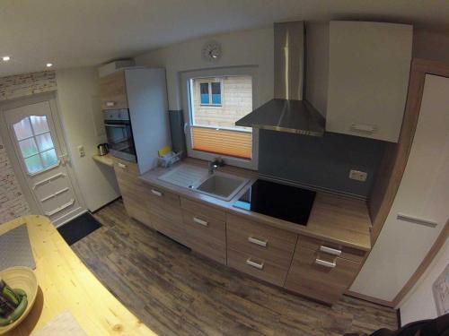 a kitchen with a sink and a stove at Spreewaldhäuser Wiesner in Lübbenau