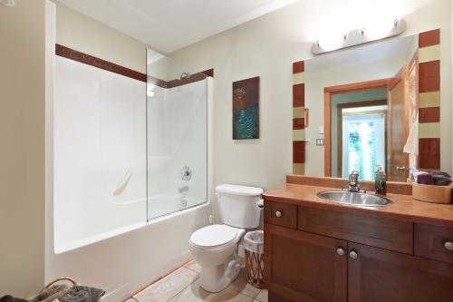a bathroom with a toilet and a sink at Buckley Bay Beach House in Courtenay