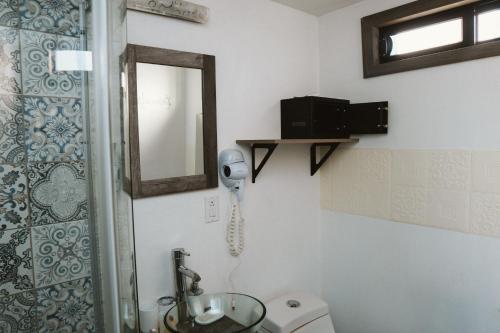 a bathroom with a shower and a sink and a mirror at La Finca de Vane in Valle de Guadalupe