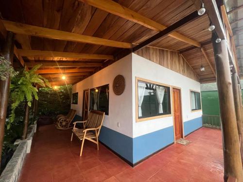 a covered patio with a table and chairs at Casa Típica La Cruz in Monteverde Costa Rica