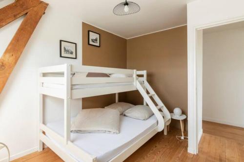 a white bunk bed in a room at Le gîte du Papillon - Normandy Holiday Cottage in Neufchâtel-en-Bray