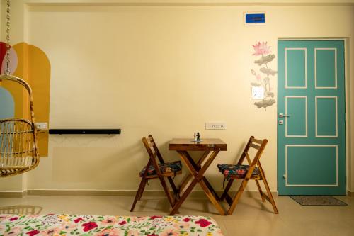 a room with a table and chairs and a door at La Mira Casa Karjat in Karjat