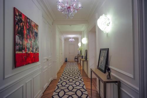a hallway with a painting on the wall and a chandelier at Relais12bis Bed & Breakfast By Eiffel Tower in Paris