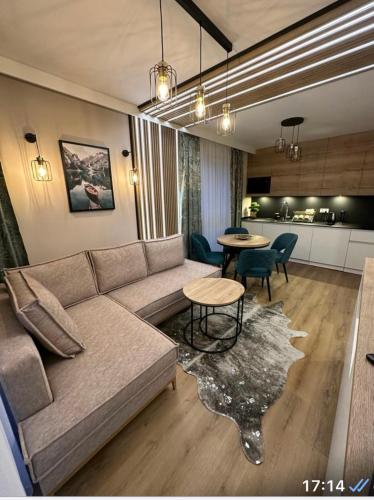 a living room with a couch and a table at JHM Apart in Zakopane
