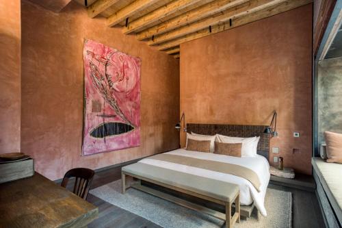a bedroom with a bed and a painting on the wall at Casa Tenue in Mexico City