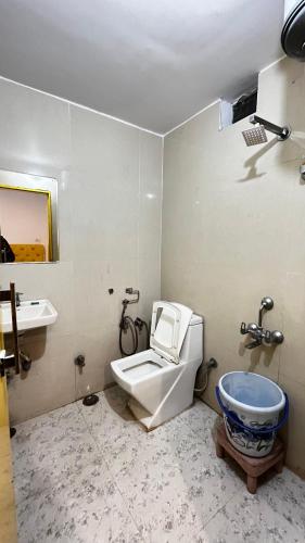 a bathroom with a toilet and a sink at The Ortus Stays -The Sunset Room in Orchha