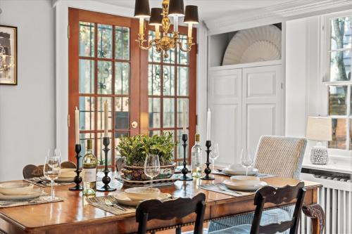 a dining room with a table with chairs and a chandelier at The Piedmont in Alexandria