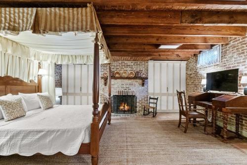 a bedroom with a bed and a fireplace and a piano at The Piedmont in Alexandria