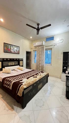a bedroom with a bed and a ceiling fan at The Ortus Suites by BnBGuys in Orchha