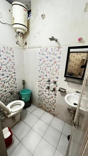 a bathroom with a toilet and a sink at The Ortus Suites by BnBGuys in Orchha