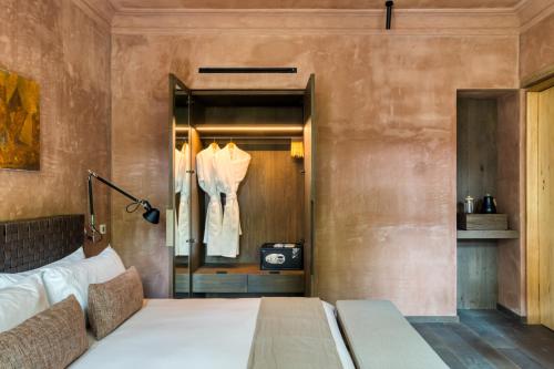 a bedroom with a large bed and a closet at Casa Tenue in Mexico City