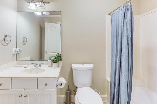 a bathroom with a toilet and a sink and a mirror at Home Theater and Yard Family Retreat in Bessemer in Bessemer
