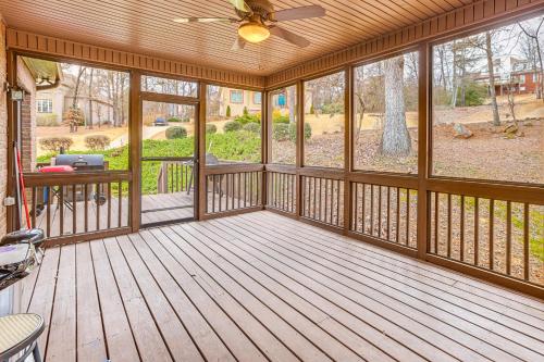 a screened in porch with a ceiling fan and windows at Home Theater and Yard Family Retreat in Bessemer in Bessemer