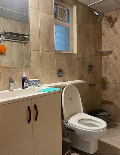 a bathroom with a toilet and a sink at Luxury 1bhk in Manyata Thanisandra in Bengaluru