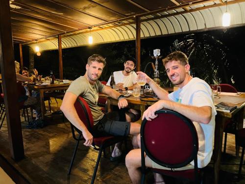 two men sitting at a table in a restaurant at Hotel 4 U Saliya Garden in Anuradhapura