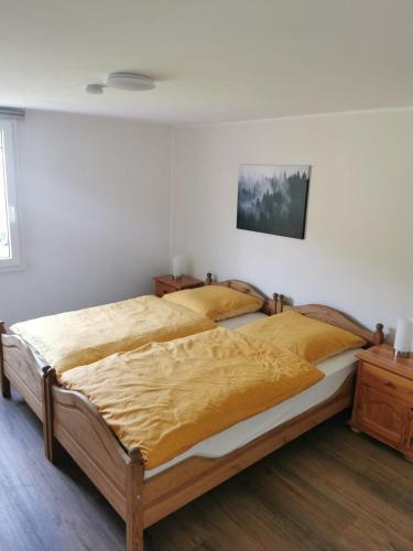 a bedroom with a large bed with a yellow blanket at Ruridylle IV in Simmerath