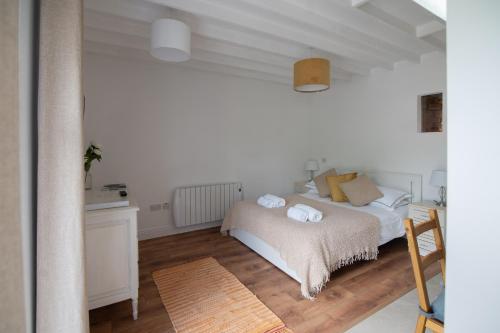a bedroom with a bed with two towels on it at The Oak Studio-Kilpatrick Glebe, Pet Friendly in Wexford