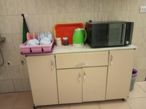 a microwave oven sitting on top of a counter at cairo backpacker in Cairo