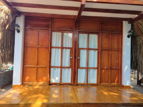 a pair of doors in a room with wooden floors at Isla Los Erizos EcoHouse in Isla Grande