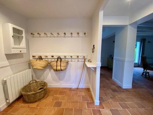 un couloir avec des paniers sur le mur d'une chambre dans l'établissement Kerlou, à Crozon