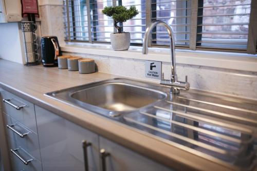 a stainless steel sink in a kitchen with a window at Detached Property With Secure Compound Parking in Grimsby