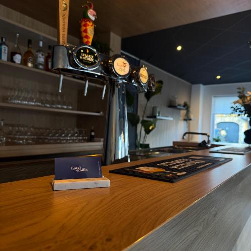 a bar with a book on top of a counter at Hotel Emilia in Kaatsheuvel