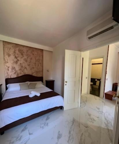 a bedroom with a large bed and a bathroom at Villa Edelweiss in Bacoli