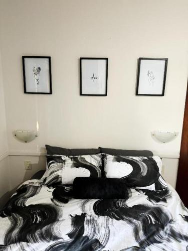 a bedroom with a bed with a black and white blanket at DUNIYA HOMES in Pretoria