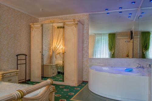 a large bathroom with a tub and a large mirror at Britaniya in Kharkiv