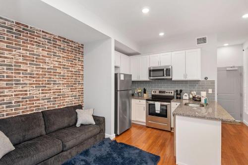 a living room with a couch and a kitchen at Sleep like a King - OTR- Free Light Rail ! in Cincinnati