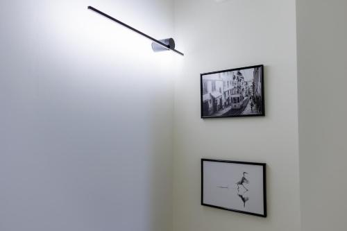 a wall with three framed pictures on a wall at BOUTiE City Centre in Kalamata