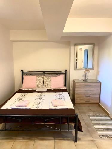 a bedroom with a bed with a mirror and a dresser at Evilion Ktima Argyropoulou in Katarrákhion