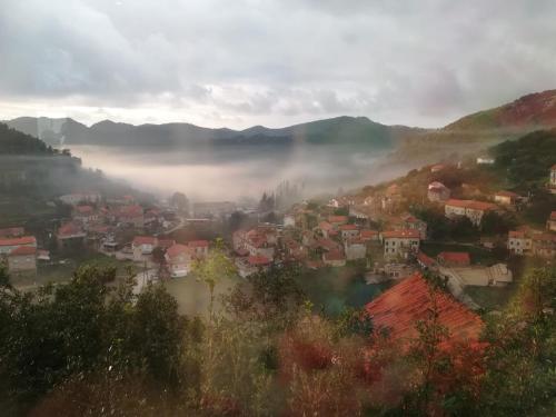 a city in the fog with houses and mountains at Villa Marisari in Otok Lastovo
