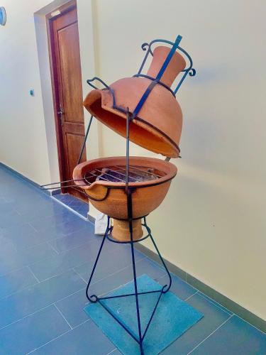 a mortar and pestle on a stand in a room at Waveside surf house in Tamraght Oufella