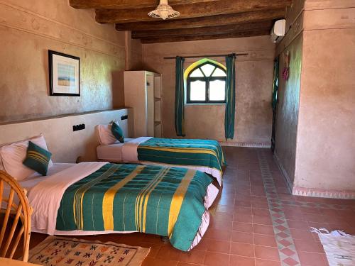 Postel nebo postele na pokoji v ubytování Kasbah Zitoune