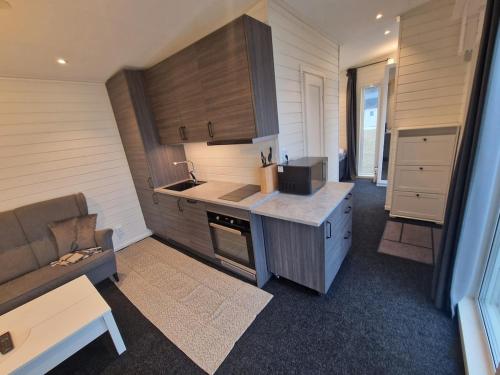 a kitchen with a counter and a couch in a room at River house in Bergsboda