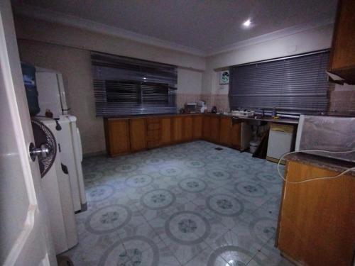 a kitchen with a refrigerator and a counter top at جبل تقوق فيلا عبدالله محروس in Nag` el-Ramla