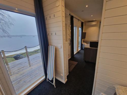 a room with a large window with a view of the ocean at River house in Bergsboda