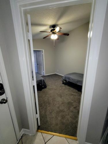a bedroom with a ceiling fan and a bed at Fresh CrashPads 2 in Houston