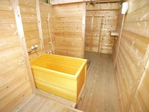 a wooden sauna with a wooden tub in a room at Hotel Shin Makomo - Vacation STAY 32738v in Itako