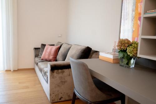 a living room with a couch and a table at Milanese LODGE/Luxury House in the heart of Milan in Milan
