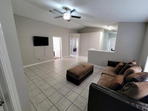 a living room with a couch and a flat screen tv at Fresh CrashPads 2 in Houston