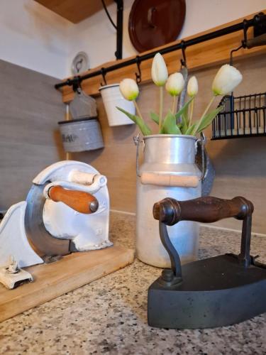 a sink with a faucet and a vase with flowers at Gästehaus Wagner in Chemnitz
