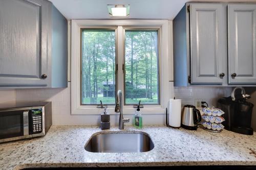 a kitchen with a sink and a window at Dreamy Lake House - Fireplace, Firepit & Pet Friendly in Pocono Lake