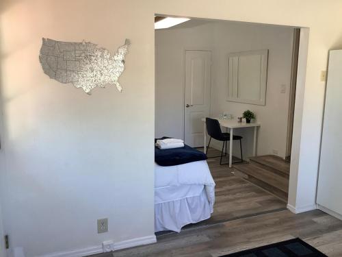 a bedroom with a bed and a table with a chair at Jacob's Well in Redding