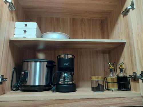 a coffee maker on a shelf in a kitchen at The Solace Place- Near Nuvali Sta Rosa Laguna in Bayabasan