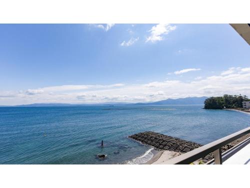 a view of the ocean from a balcony at Ibusuki Kaijo Hotel - Vacation STAY 87380v in Ibusuki