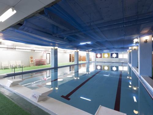 a large indoor swimming pool with blue ceilings at Ibusuki Kaijo Hotel - Vacation STAY 87382v in Ibusuki